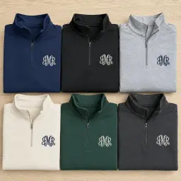 The six colours of the monogram quarter-zip: navy, black, heather grey, bone, alpine green, asphalt