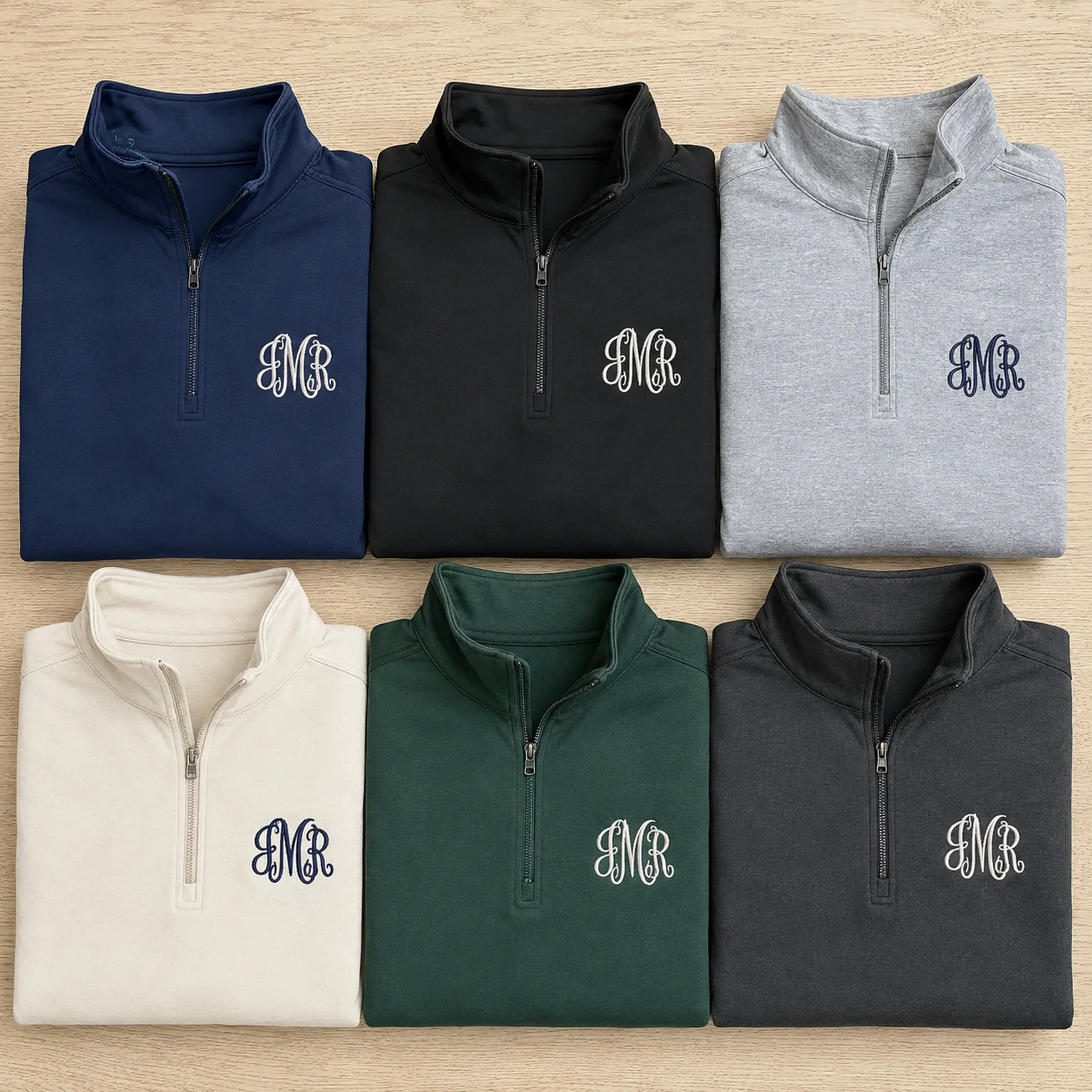 The six colours of the monogram quarter-zip: navy, black, heather grey, bone, alpine green, asphalt