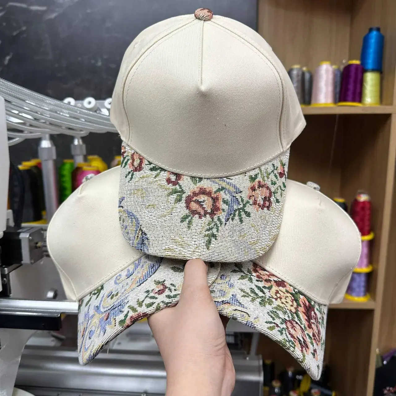 Cream cap with floral tapestry brim and embroidered text