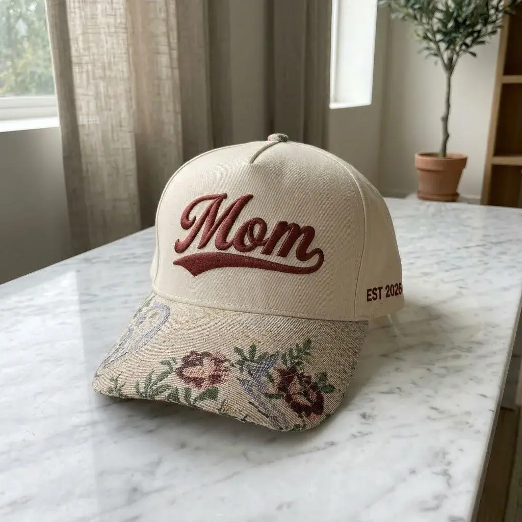 Cream cap with floral tapestry brim and embroidered text